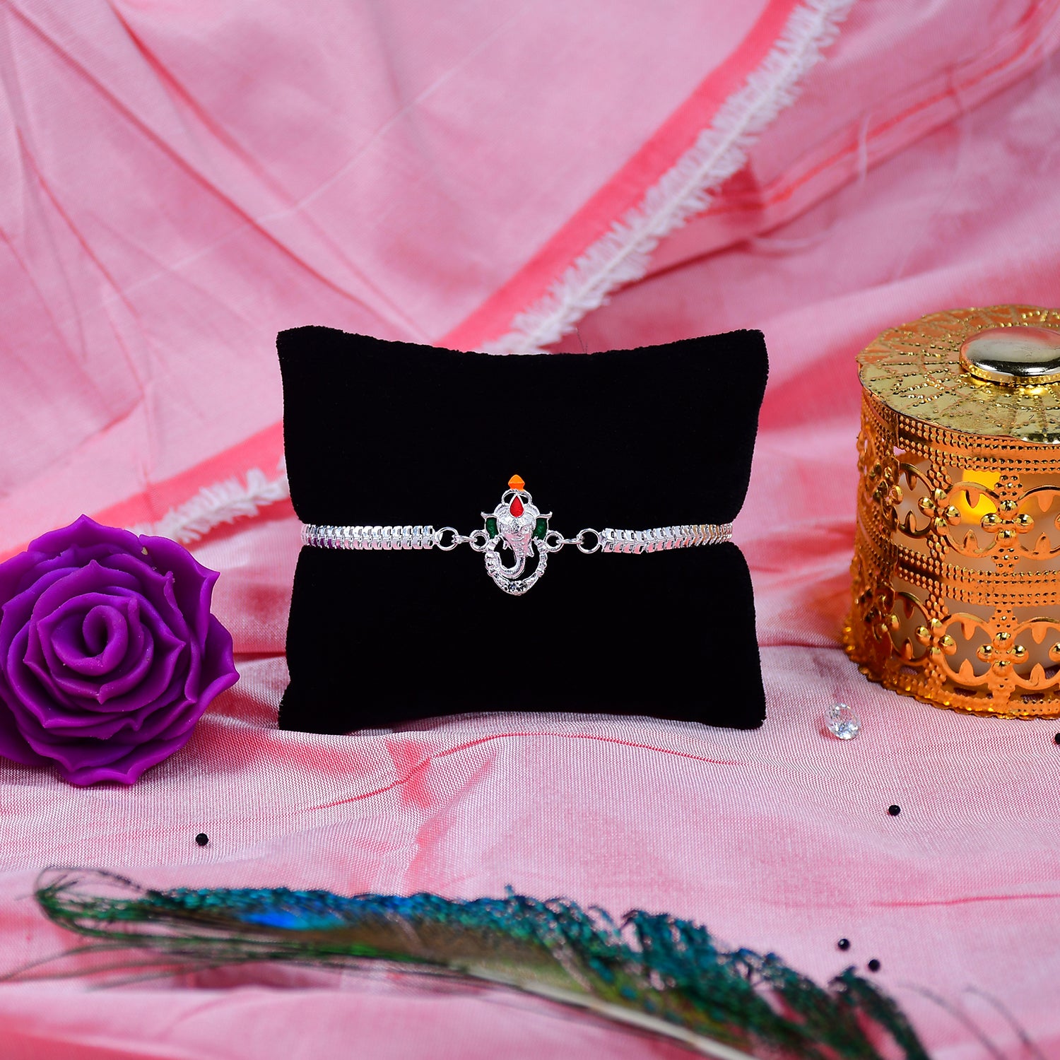 Stylish Ganesha Rakhi With Enamel Highlights And Silver Metal Chain Stylish Ganesha Rakhi With Enamel Highlights And Silver Metal Chain